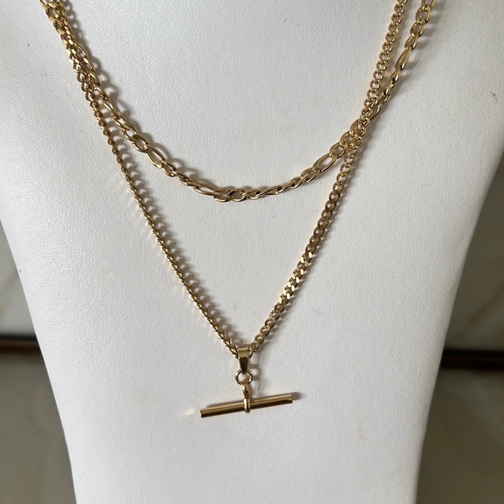 two layered necklaces in gold with fob