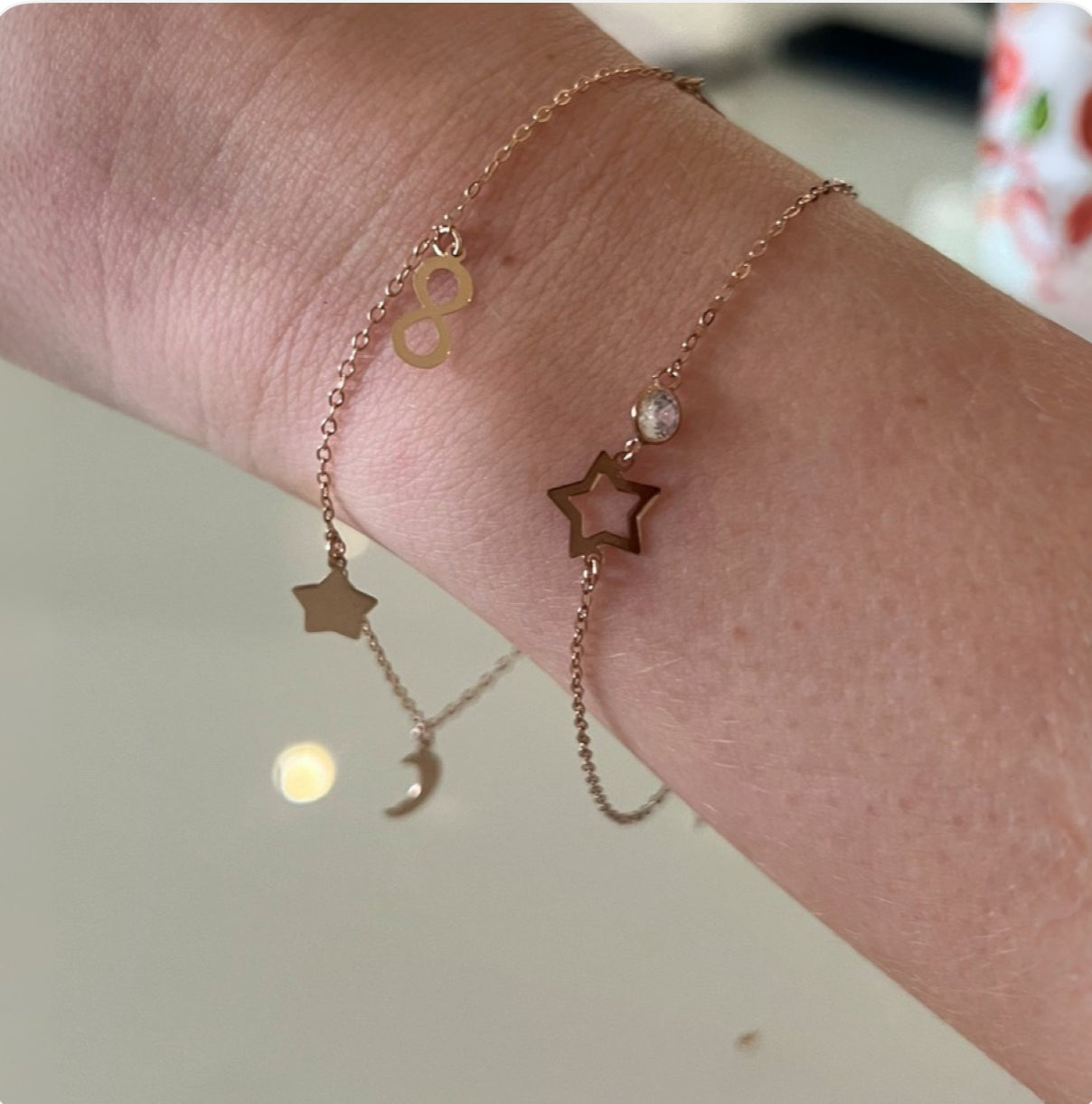 charm bracelet in 9ct yellow gold with horseshoe, flower, infinity, moon and star charm bracelet