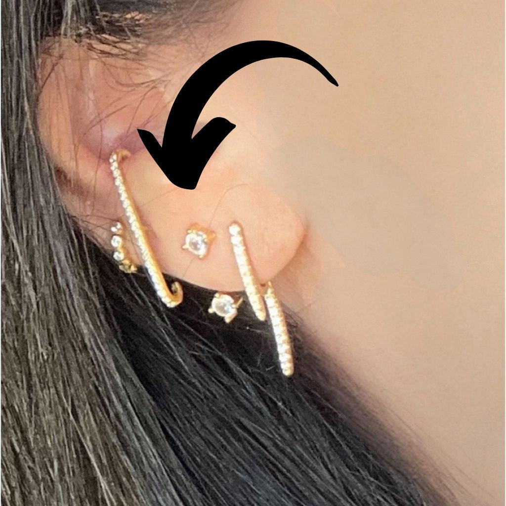 stack of earrings highlighting the front and back single stud earring with cubic zirconias front and back