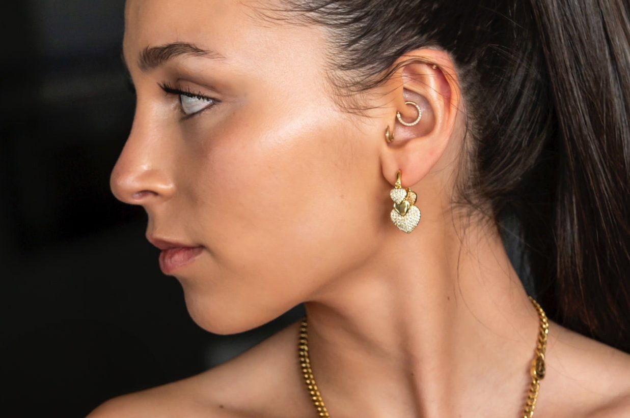 Heart Charm Huggie Earrings in gold with cubic zirconias
