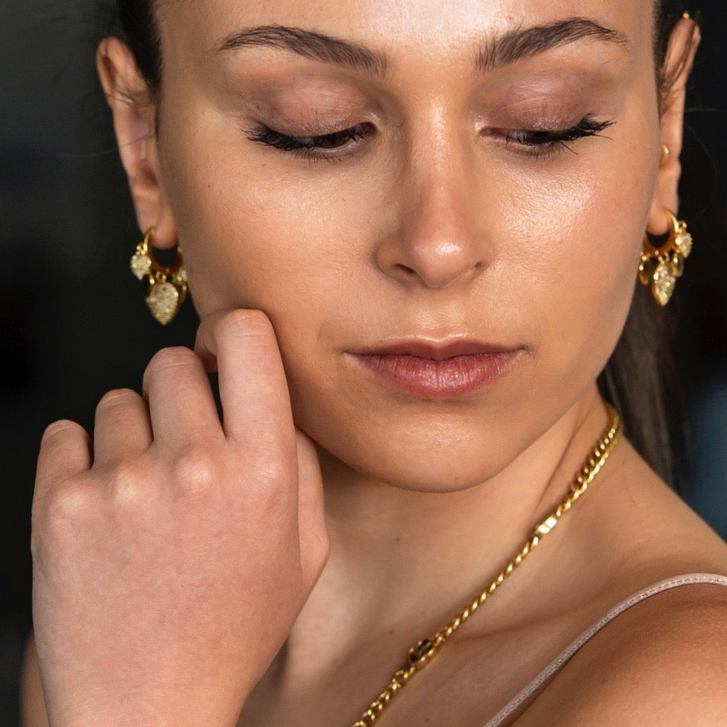 Heart Charm Huggie Earrings in gold with cubic zirconias