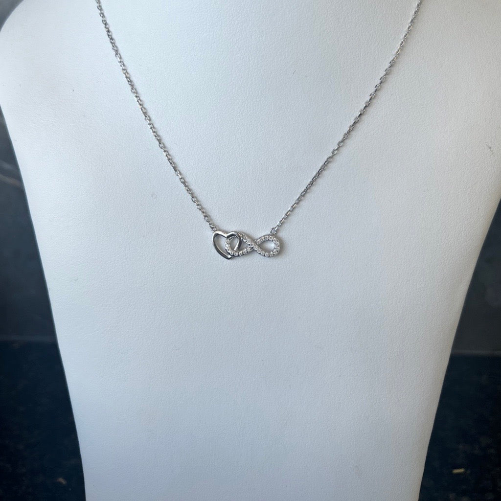 infinity heart pendant necklace with silver heart and infinity sign covered in cubic zirconias intertwined
