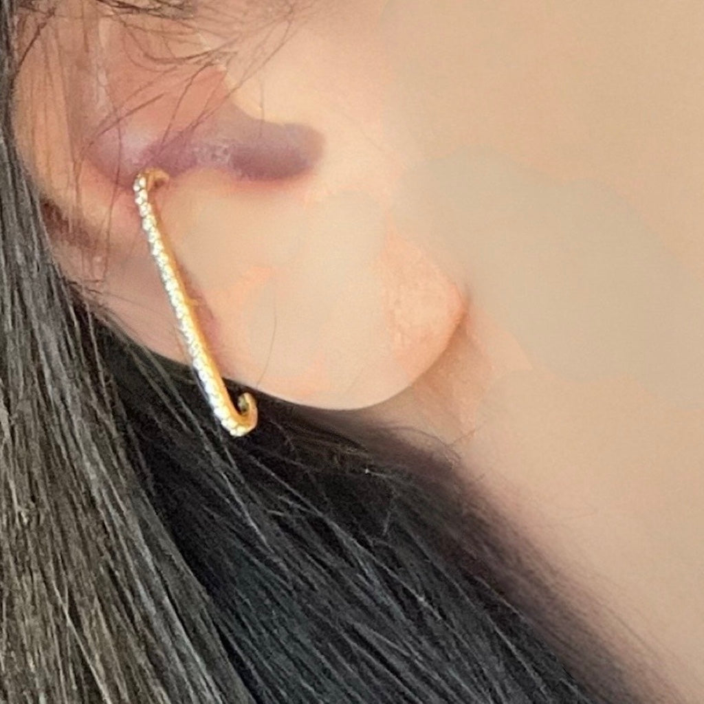 gold stud with cubic zirconias wrapped over the ear