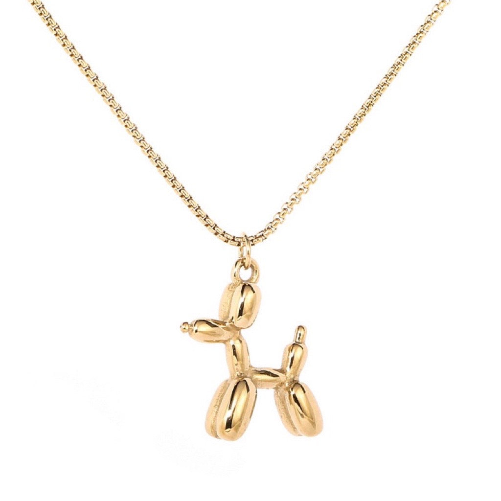 yellow gold balloon dog penant on a gold chain