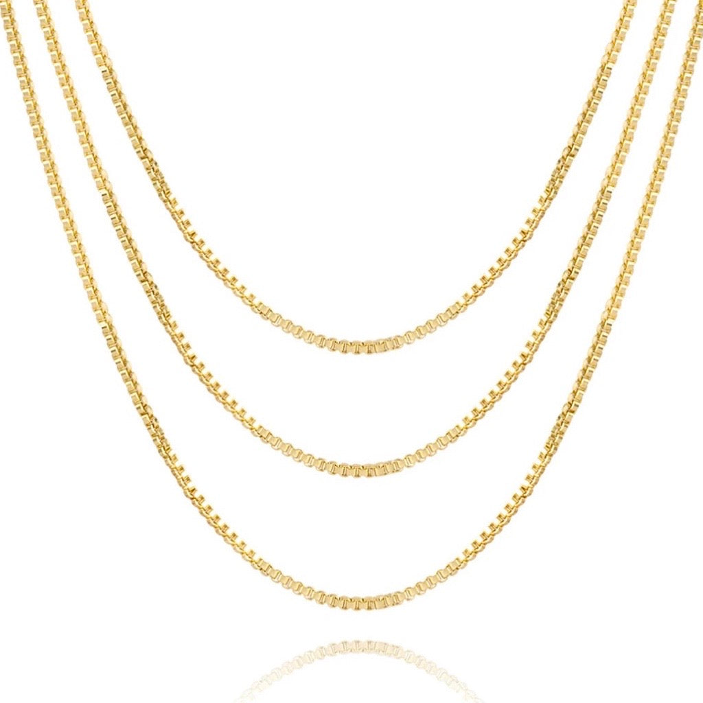 three box chain necklaces layered in 14k gold