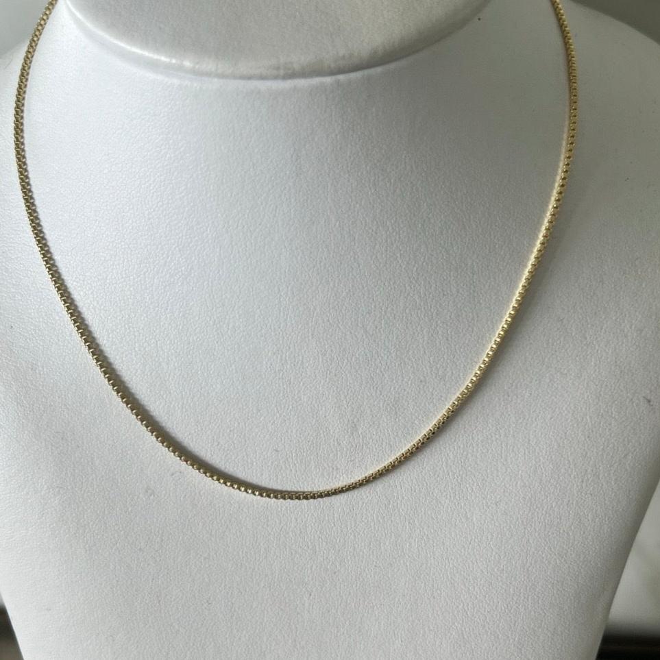three box chain necklaces layered in 14k gold