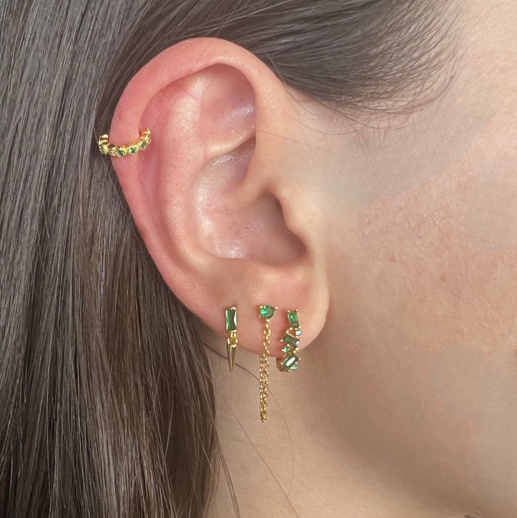 chain drop earrings in emeral green and gold on models ear with complimentary earrings for stacking