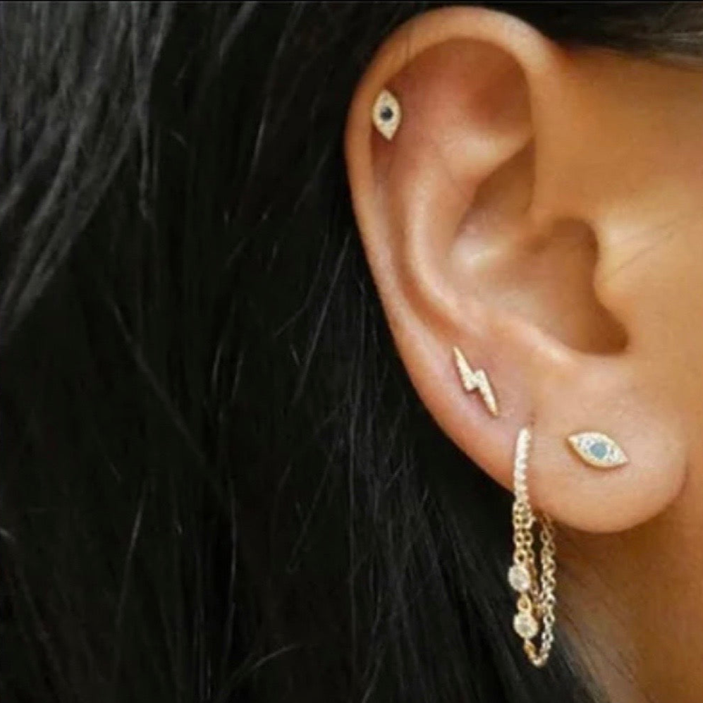 huggie earrings with two chains and embellished with cubic zirconias