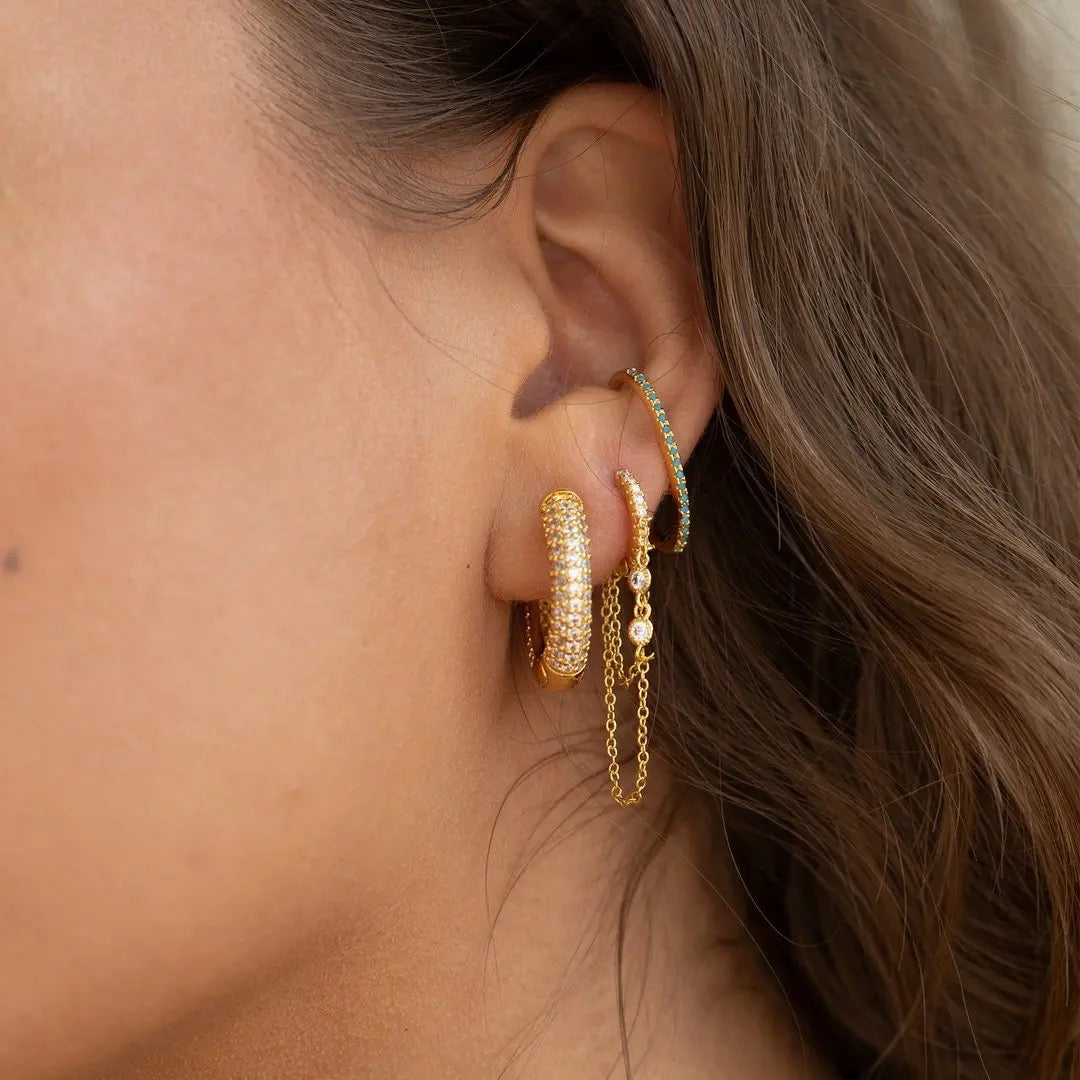 huggie earrings with two chains and embellished with cubic zirconias