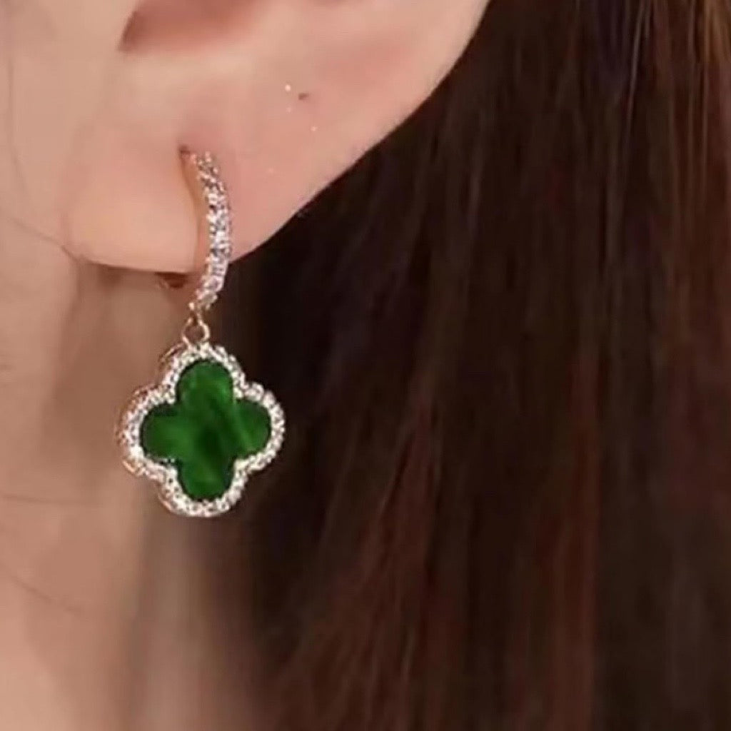 green and gold clover earring in models ear