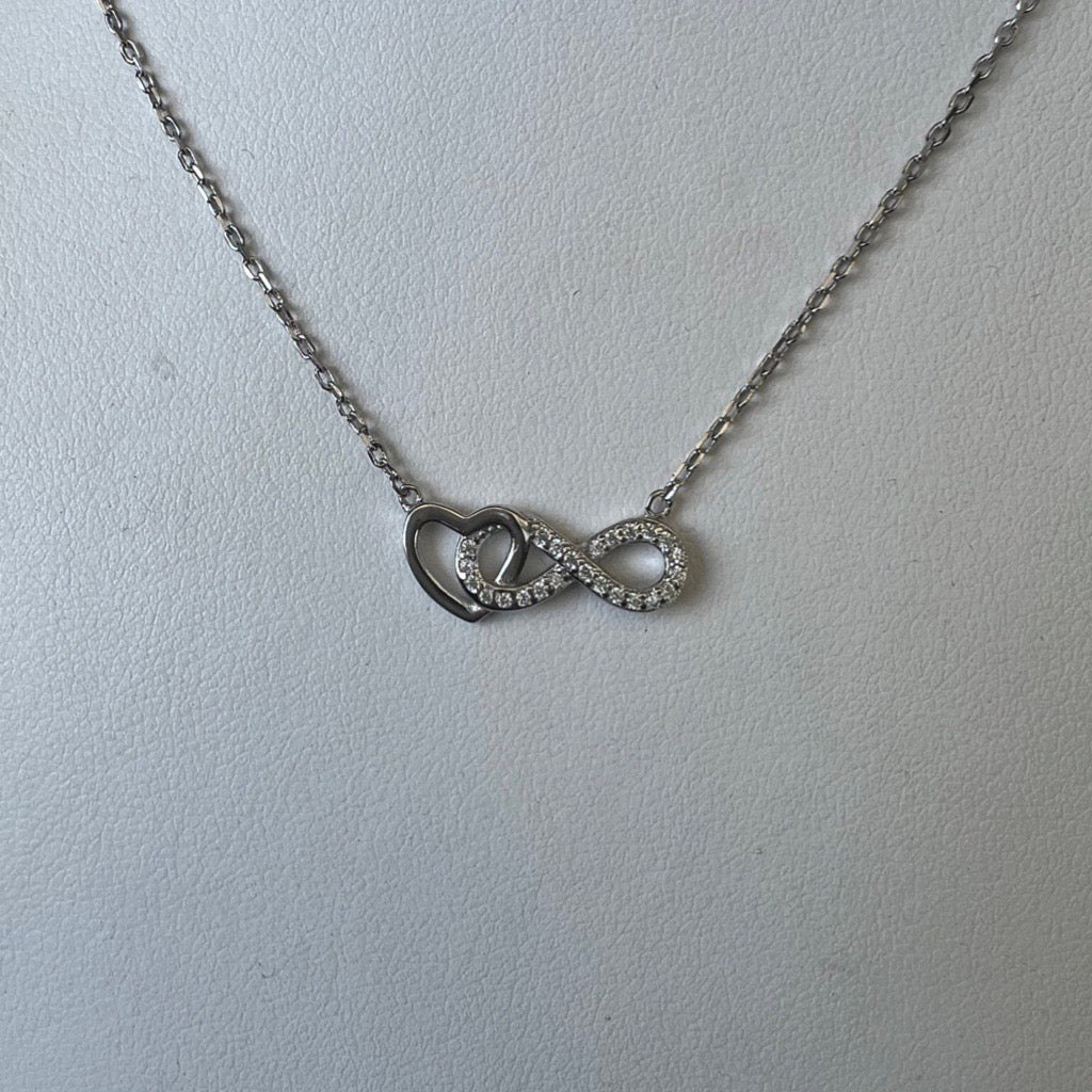 infinity heart pendant necklace with silver heart and infinity sign covered in cubic zirconias intertwined