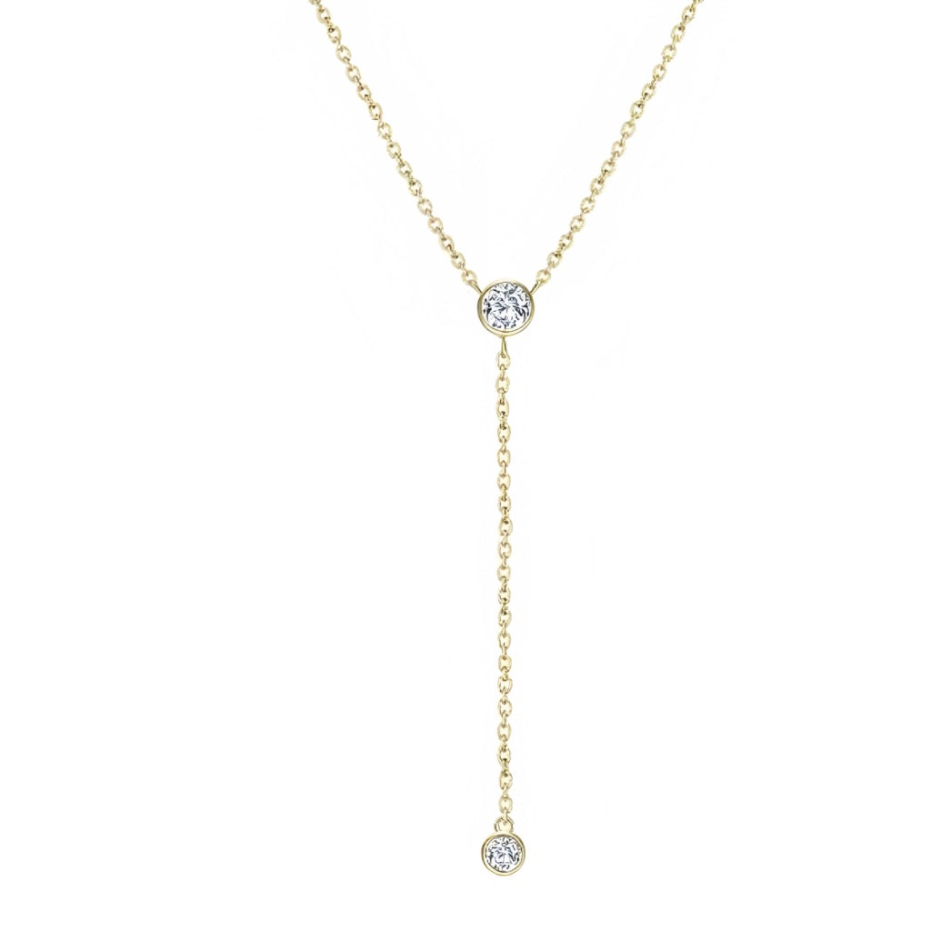 lariat necklace with a gold chain and centre piece cubic zirconia and a second cubic zirconia at the end of the lariat. both cubic zirconias are in a bezel setting