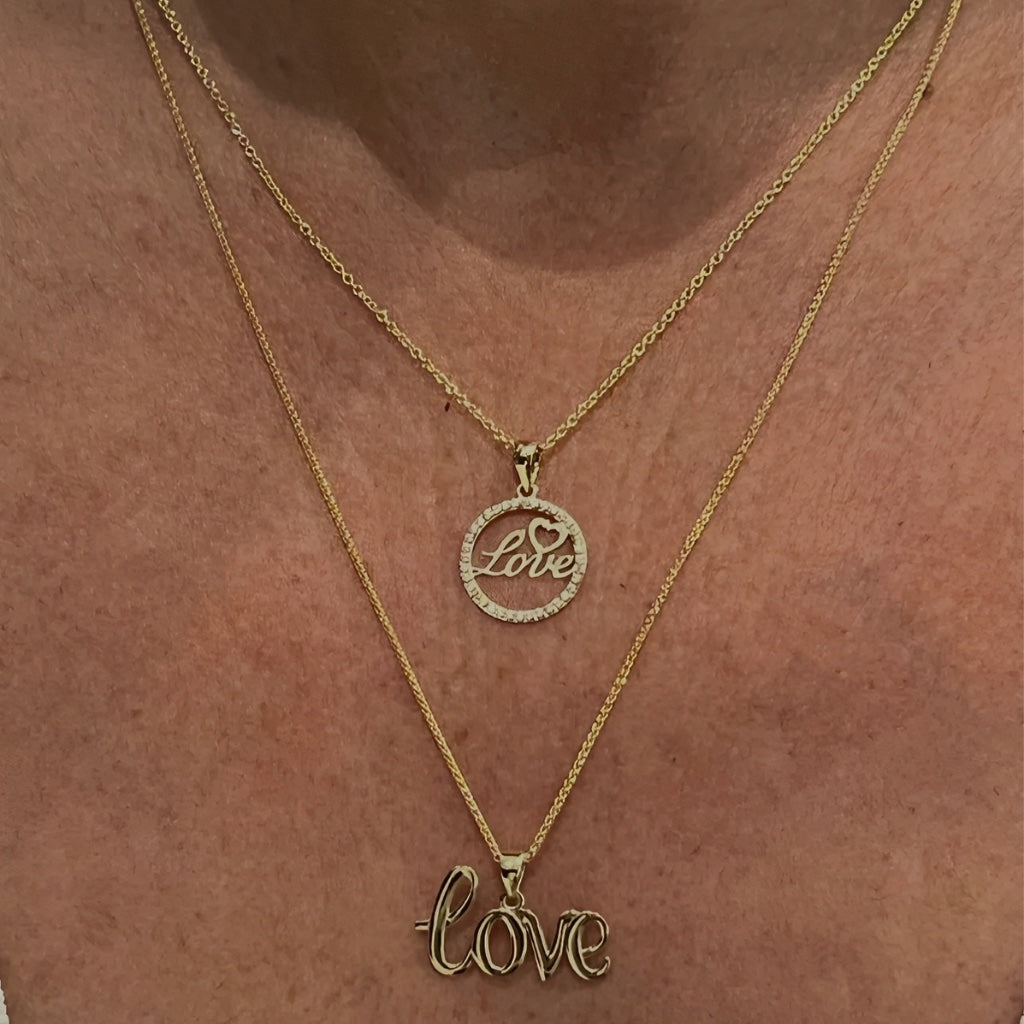 love pendant on a chain on models neck