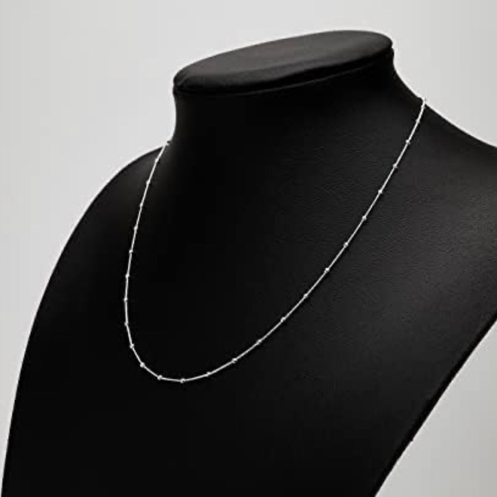 silver beaded necklace on mannequin