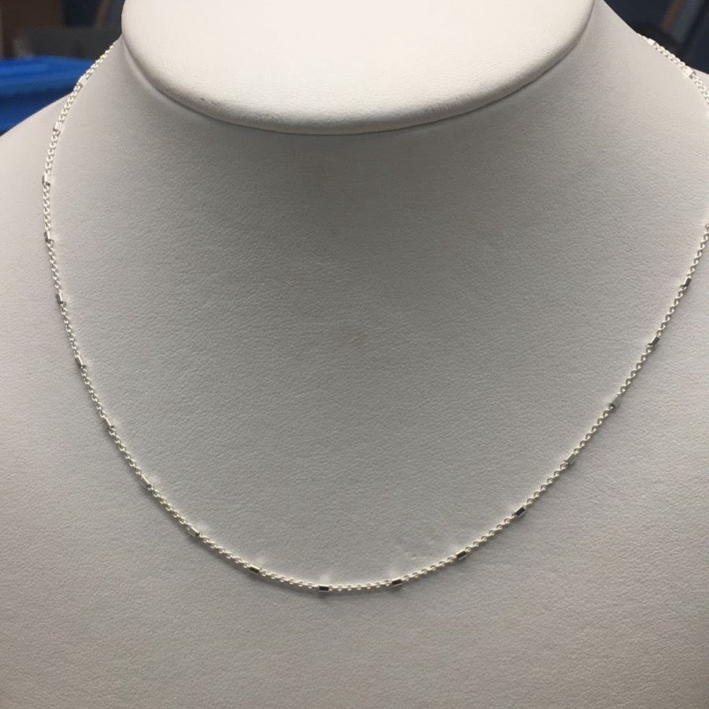 square tube necklace in silver on mannequin 