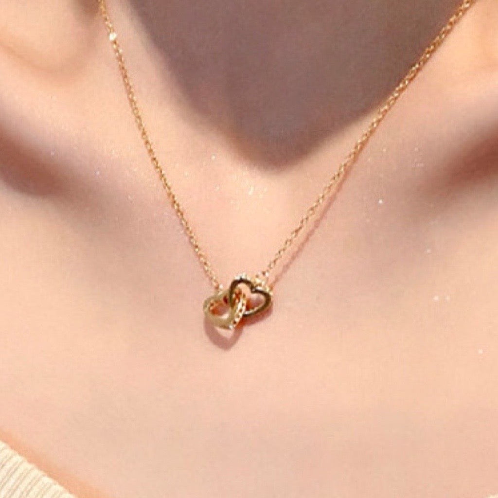twin hearts necklace in gold on model 